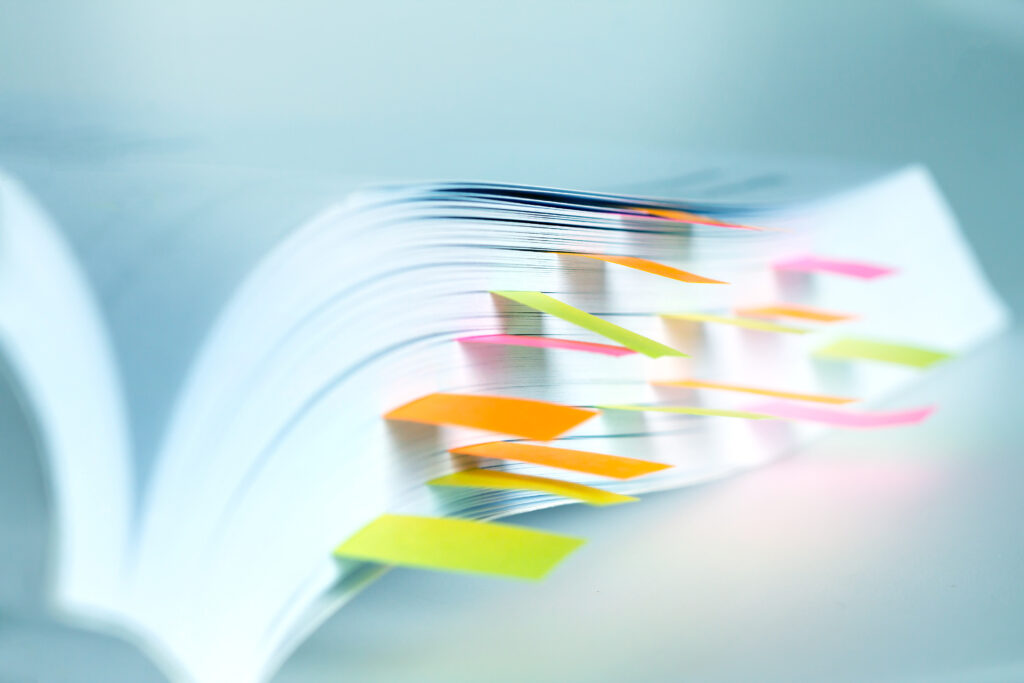 Close up White book marked by sticky note